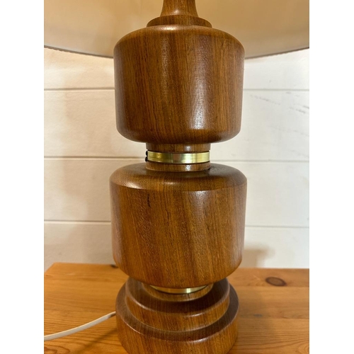 230 - An oak turned table lamp with brass banding