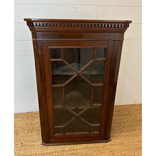 24 - A mahogany glazed corner cabinet (H93cm W60cm D42cm)