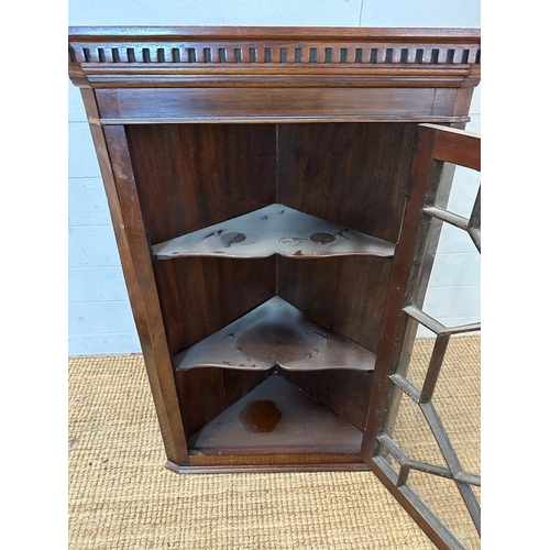 24 - A mahogany glazed corner cabinet (H93cm W60cm D42cm)