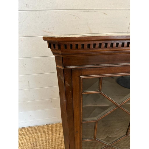 24 - A mahogany glazed corner cabinet (H93cm W60cm D42cm)