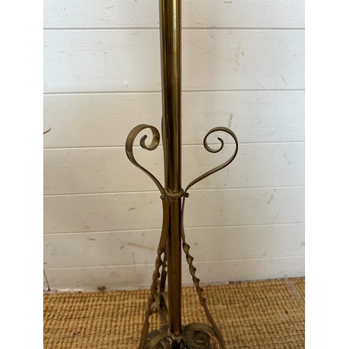 241 - A brass floor standing lamp on scrolling feet (H180cm)