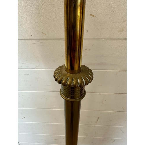 241 - A brass floor standing lamp on scrolling feet (H180cm)