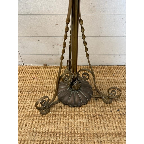 241 - A brass floor standing lamp on scrolling feet (H180cm)