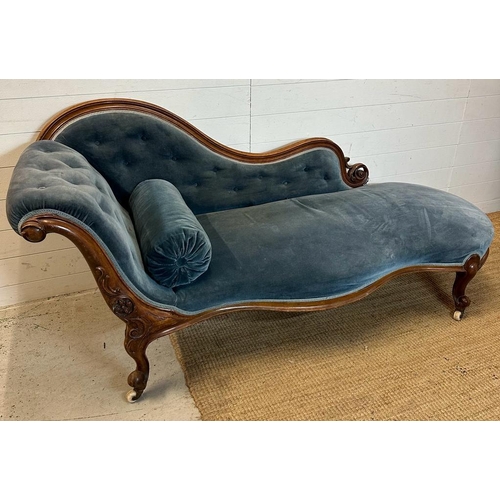 25 - A Victorian blue upholstered chaise longue with button back on a carved mahogany frame (H85cm W190cm... 