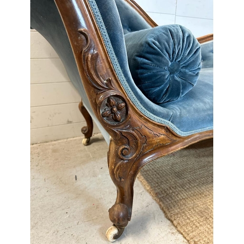 25 - A Victorian blue upholstered chaise longue with button back on a carved mahogany frame (H85cm W190cm... 