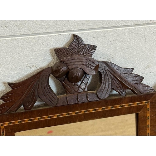 264 - A pair of mahogany mirrors with marquetry inlay and acorn carved tops 60cm x 28cm