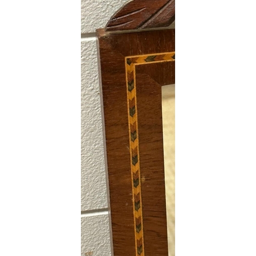 264 - A pair of mahogany mirrors with marquetry inlay and acorn carved tops 60cm x 28cm