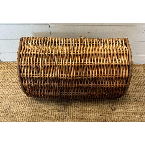 27 - A wicker three quarto barrel shaped log basket (W64cm)