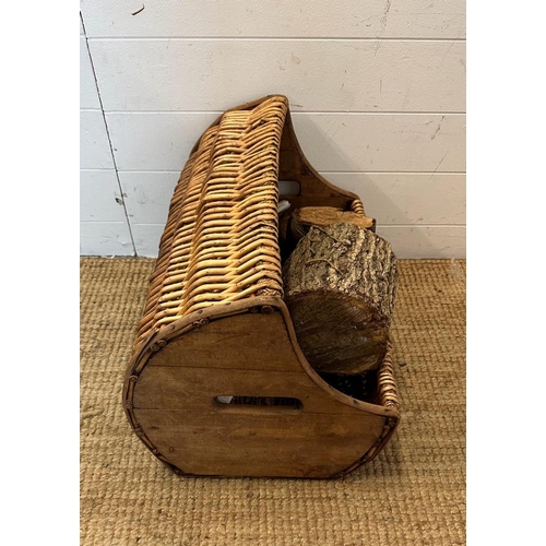 27 - A wicker three quarto barrel shaped log basket (W64cm)