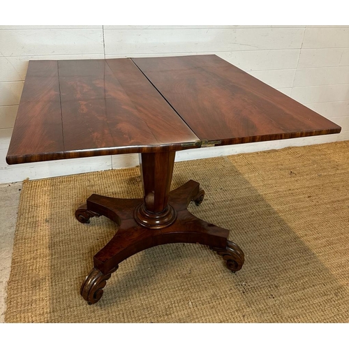 29 - A Regency style mahogany fold over tea table with hexagonal central support terminating on four scro... 