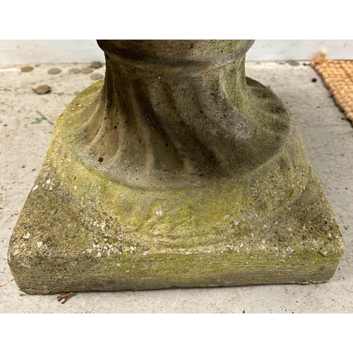 290 - A weathered concrete garden urn with a grape vine design on a square base (H65cm Dia60m)