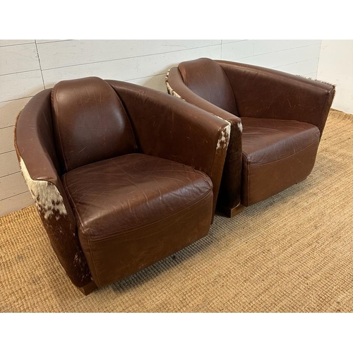 3 - Two cow hide backed brown tub chairs