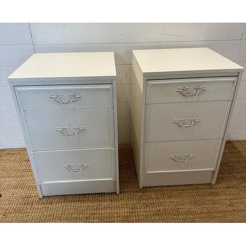 31 - A pair of white bedside tables with Louis style handles (H69cm W44cm D42cm)