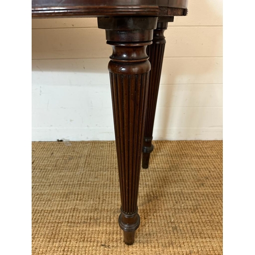 34 - A mahogany carved console table with four drawers on fluted legs (H80cm W176cm D38cm)