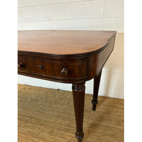 34 - A mahogany carved console table with four drawers on fluted legs (H80cm W176cm D38cm)