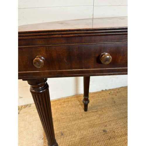 34 - A mahogany carved console table with four drawers on fluted legs (H80cm W176cm D38cm)