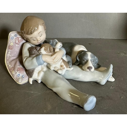 348 - Two golfing Lladro figures and a young boy with puppet