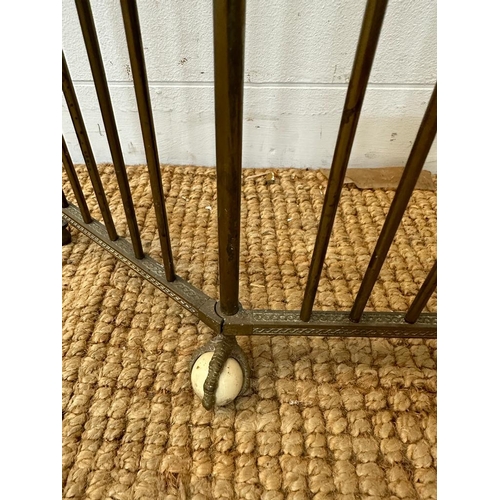 36 - A brass foldable fire guard on claw and ball feet (H50cm W70cm)