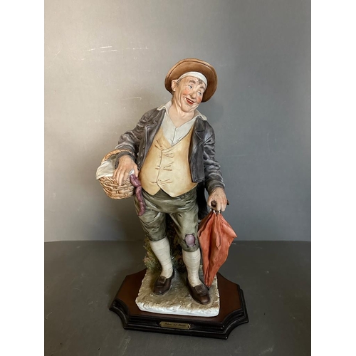 366 - A selection of four Capodimonte figures to include Gentleman on benches, a man with a basket and a l... 