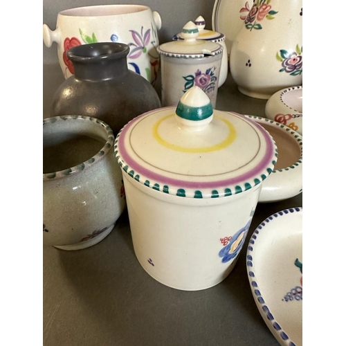 390 - A selection of Poole pottery to include pots, dishes and biscuit barrels