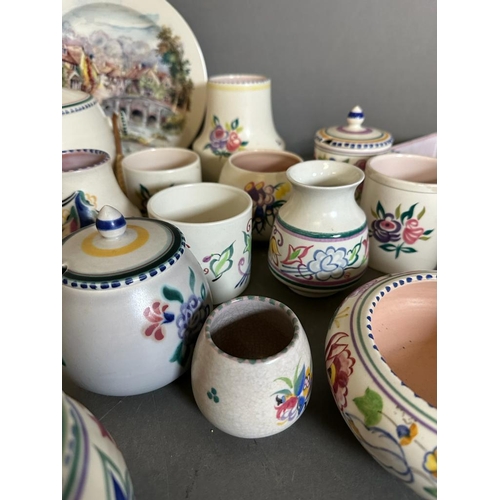 390 - A selection of Poole pottery to include pots, dishes and biscuit barrels