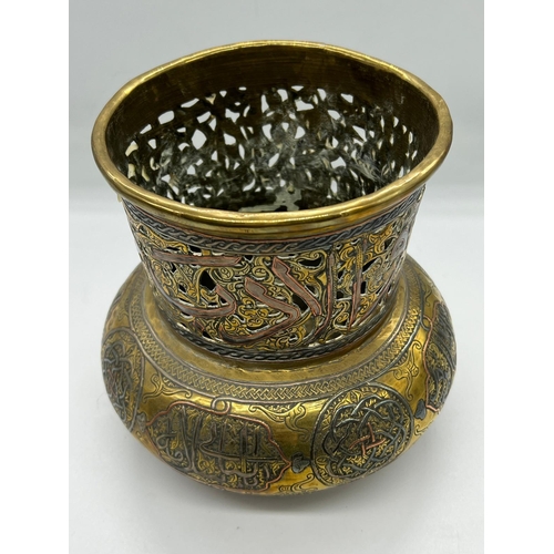 393 - An Islamic vase, the brass vessel is inlaid with copper and Arabic calligraphy (H17cm Dia15cm)