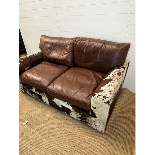 4 - A two seater leather and cow hide sofa (H84cm 175cm D95cm SH41cm)