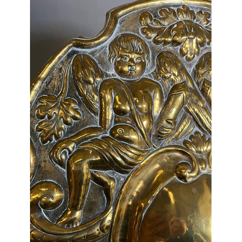 402 - A pair of brass wall sconce, cast backplate with winged cherubs and twin arm candle holders