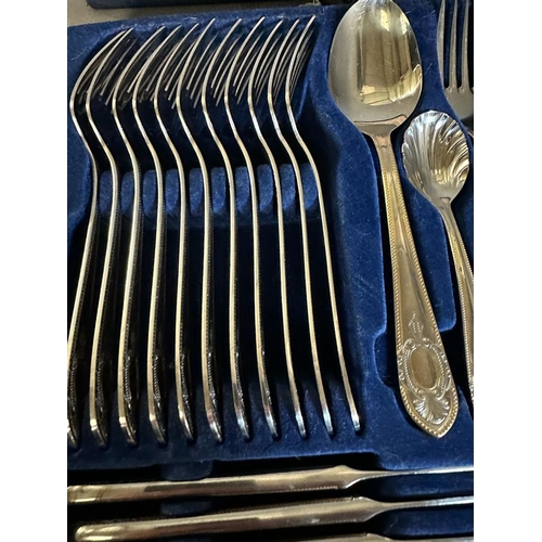 418 - A twelve place setting canteen of cutlery by SBS in a blue leather case.