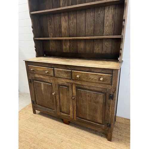 42 - A rustic oak dresser, Plate rack sits on a base comprising of drawers and cupboards (H193cm W138cm D... 