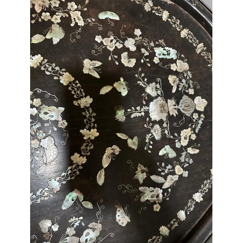 422 - An oval oriental ebony tray with a floral mother of pearl inlay on stand 84cm x 52cm