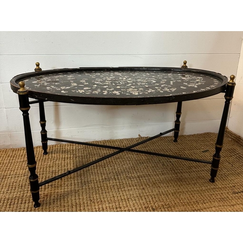 422 - An oval oriental ebony tray with a floral mother of pearl inlay on stand 84cm x 52cm