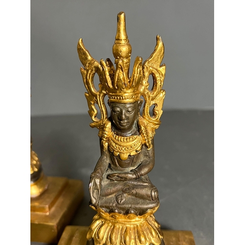 423 - Two Buddha statues on wooden gilt bases