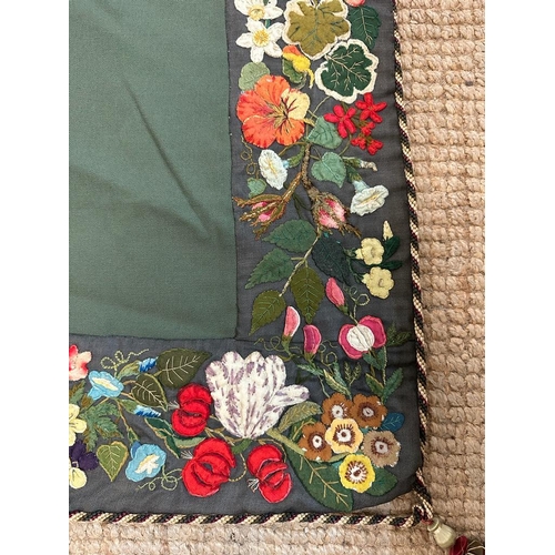 428 - A green applique table cloth or wall hanging with a floral border 96cm x 96cm