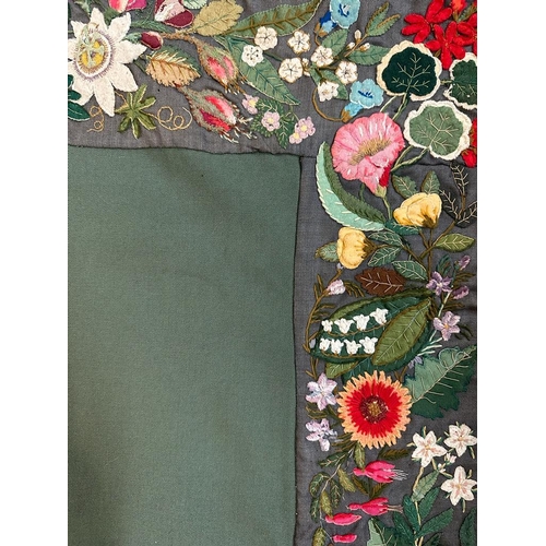 428 - A green applique table cloth or wall hanging with a floral border 96cm x 96cm