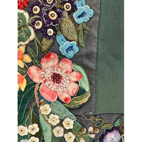 428 - A green applique table cloth or wall hanging with a floral border 96cm x 96cm