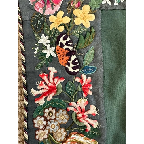 428 - A green applique table cloth or wall hanging with a floral border 96cm x 96cm