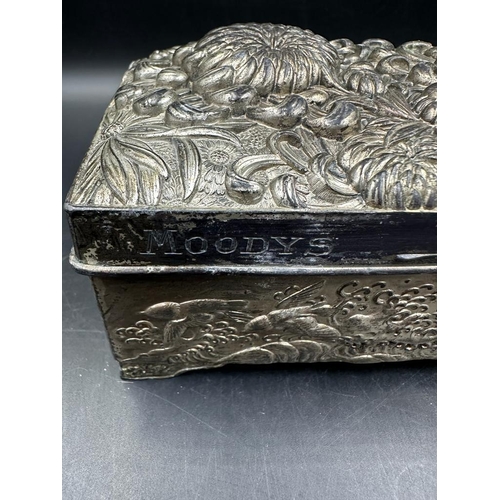 439 - A hammered white metal cigarette box with floral motif, inscribed 