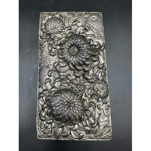 439 - A hammered white metal cigarette box with floral motif, inscribed 