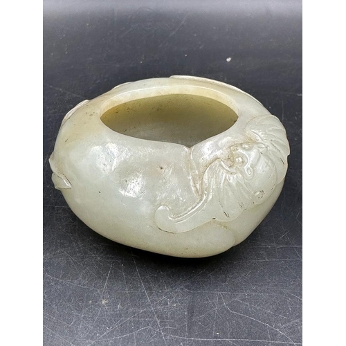 458 - A Chinese jade bowl, approximate 7cm in diameter and 3cm high with floral decoration.