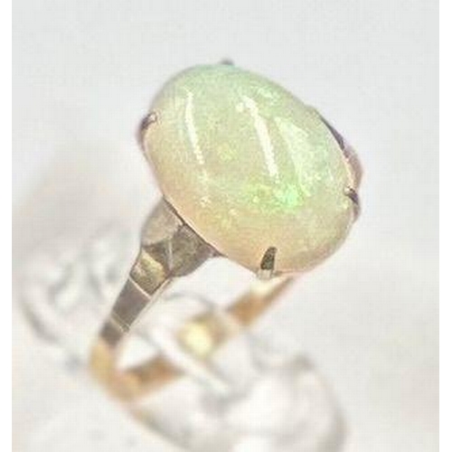 492 - A 9ct gold ring with opal central stone, approximate size K.