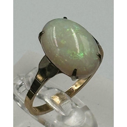 492 - A 9ct gold ring with opal central stone, approximate size K.