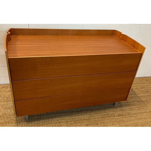 54 - A contemporary chest of drawers with three soft closing drawers and a wave design to sides, finishin... 