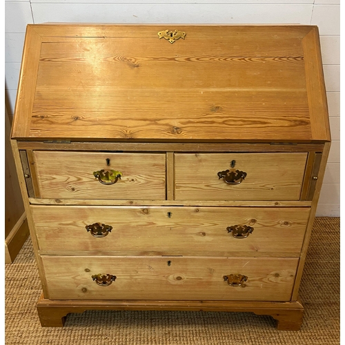 57 - A pine bureau with brass handles and drop down writing slope (H105cm W93cm D47cm)