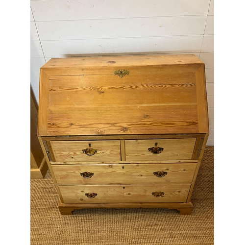 57 - A pine bureau with brass handles and drop down writing slope (H105cm W93cm D47cm)