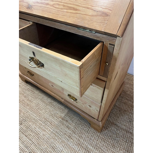 57 - A pine bureau with brass handles and drop down writing slope (H105cm W93cm D47cm)