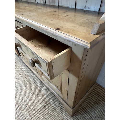 59 - A pine dresser with three shelve plate rack sat upon a three drawer over three cupboard base (H211cm... 