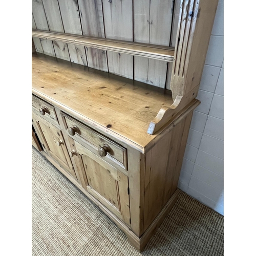 59 - A pine dresser with three shelve plate rack sat upon a three drawer over three cupboard base (H211cm... 