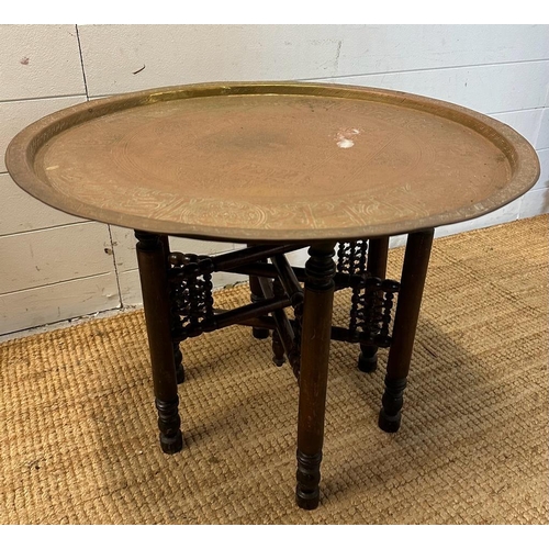 62 - A foldable brass topped Indian tea table