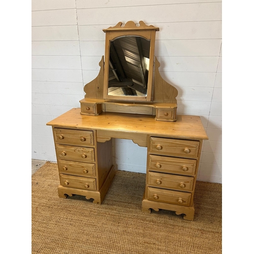 64 - A pine dressing table with four drawers each side and a pine mirror (H74cm W122cm D47cm)